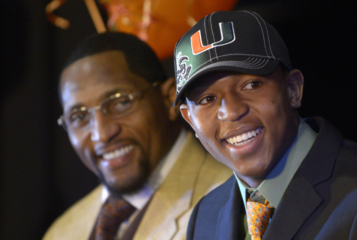 Ray Lewis III, right, seen here with his father after signing with the University of Miami in 2013. (AP Photo/Phelan M. Ebenhack)