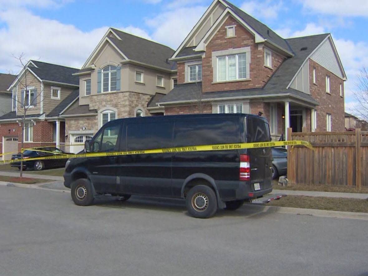 Police tape still surrounds a house in Milton where a person was shot dead early Sunday.  (CBC - image credit)