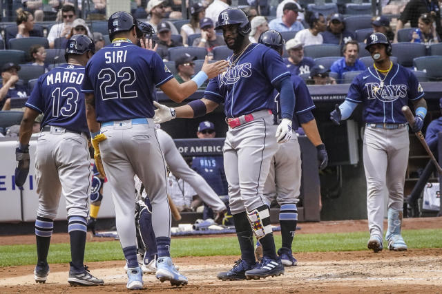 Tampa Bay Rays' Yandy Diaz, center, slap hands with teammates after hitting a grand slam in the fifth inning of a baseball game against New York Yankees, Saturday, May 13, 2023, in New York. (AP Photo/Bebeto Matthews)