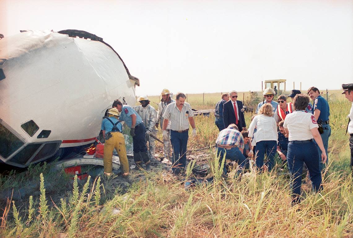 Aug. 31, 1988: Emergency workers tend to an injured person, possibly a crew member, who was pulled from the wreckage of Delta Flight 1141 after it crashed during takeoff at Dallas-Fort Worth International Airport.