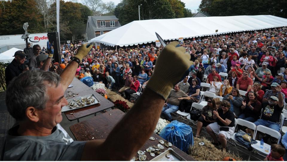 "Wild Bill" Allen of Burlington, Vermont, works the crowd after winning his heat in the preliminary round in the shucking contest at the 2013 Oysterfest.