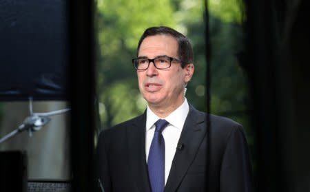 FILE PHOTO: U.S. Treasury Secretary Steve Mnuchin speaks during a TV interview at the White House in Washington, U.S., May 21, 2018. REUTERS/Kevin Lamarque