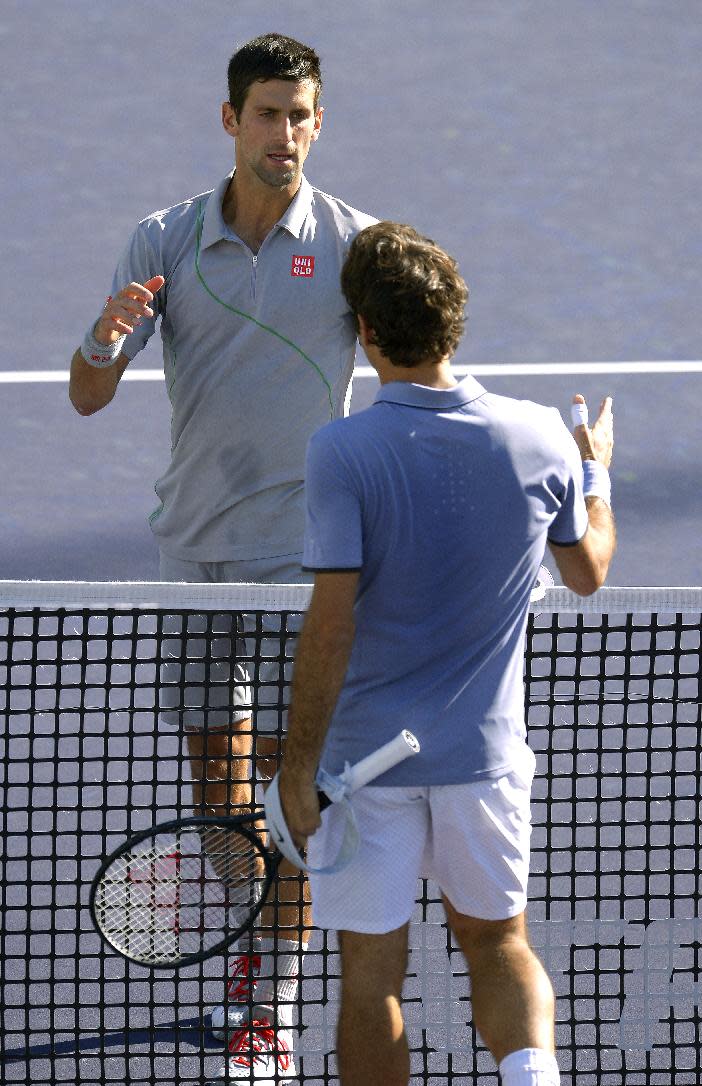 Novak Djokovic, of Serbia, left, greets Roger Federer, of Switzerland, right, across the net after Djokovic beat Federer 3-6, 6-3, 7-6 to win the final match of the BNP Paribas Open tennis tournament, Sunday, March 16, 2014, in Indian Wells, Calif. (AP Photo/Mark J. Terrill)