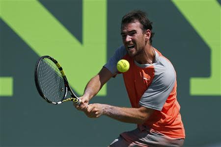 Mar 19, 2014; Miami, FL, USA; Adrian Mannarino hits a backhand against Nikolay Davydenko (not pictured) on day three of the Sony Open at Crandon Tennis Center. Mandatory Credit: Geoff Burke-USA TODAY Sports