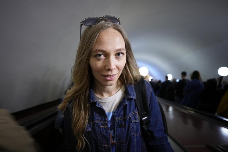 Yekaterina Maksimova poses for a photo on an escalator on the Moscow subway in Moscow, Russia, Monday, May 22, 2023. The journalist and activist has been detained five times in the past year, thanks to the system's pervasive security cameras with facial recognition. She says police would tell her the cameras "reacted" to her — although they often seemed not to understand why, and would let her go after a few hours. (AP Photo/Alexander Zemlianichenko)