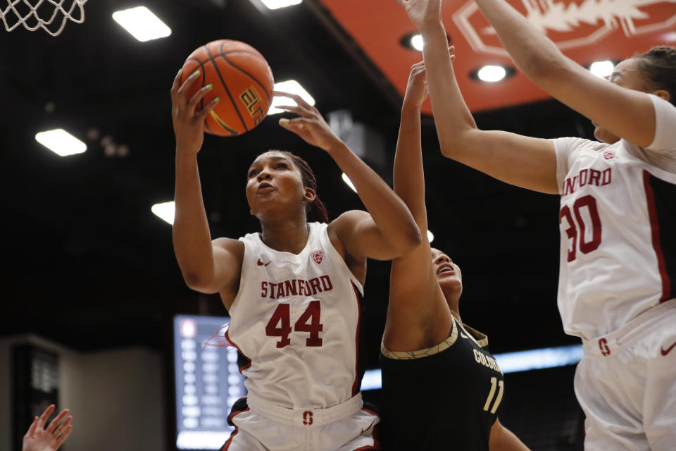 Stanford forward Kiki Iriafen (44) grabs a rebound over Colorado center Quay Miller (11) during the second quarter of an NCAA college basketball game in Stanford, Calif., Sunday, Jan. 22, 2023. (AP Photo/Jim Gensheimer)