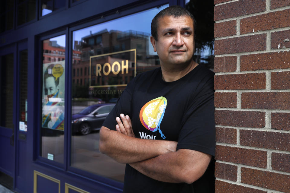 Manish Mallick, owner of the Indian restaurant ROOH, poses for a portrait outside the West Loop restaurant in Chicago on Tuesday, July 14, 2020. When Mallick opened last year, he was focused on building his business and getting rave reviews about the eatery's "progressive Indian cuisine" from the city's top critics. Now some of his biggest fans are on the city's South Side, where he regularly delivers hundreds of meals to those hardest-hit by the pandemic. (AP Photo/Charles Rex Arbogast)