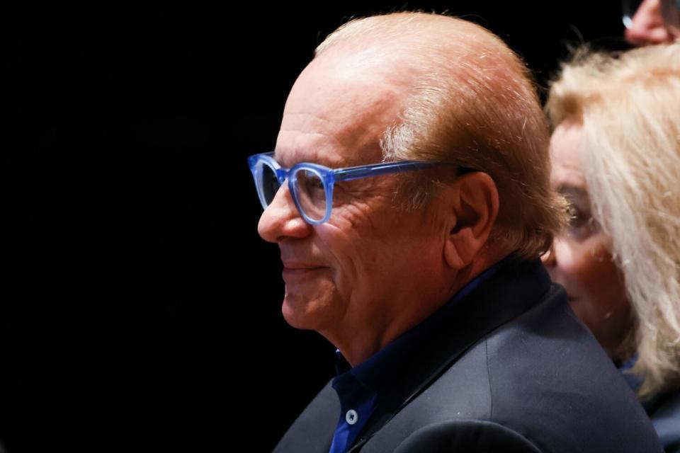 Chargers owner Dean Spanos watches from the seats during an introductory news conference for Chargers coach Jim Harbaugh.