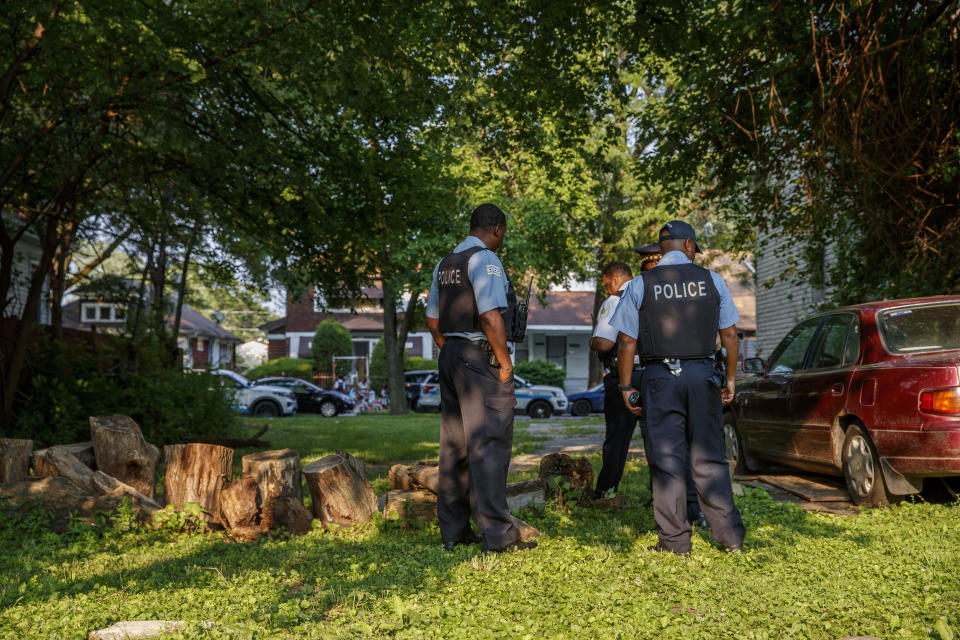 Officers work the scene where a young girl was shot in the leg in an alley on the 11700 block of South Normal Avenue in Chicago's West Pullman neighborhood Sunday July 4, 2021. (Armando L. Sanchez/Chicago Tribune via AP)