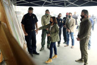 Mark Johnson, left, unit chief for Cal Fire in Fresno, watches Democratic vice presidential candidate Sen. Kamala Harris, D-Calif., and California Gov. Gavin Newsom are briefed on the damage during the Creek Fire at Pine Ridge Elementary, Tuesday, Sept. 15, 2020 in Auberry, Calif. (AP Photo/Gary Kazanjian)