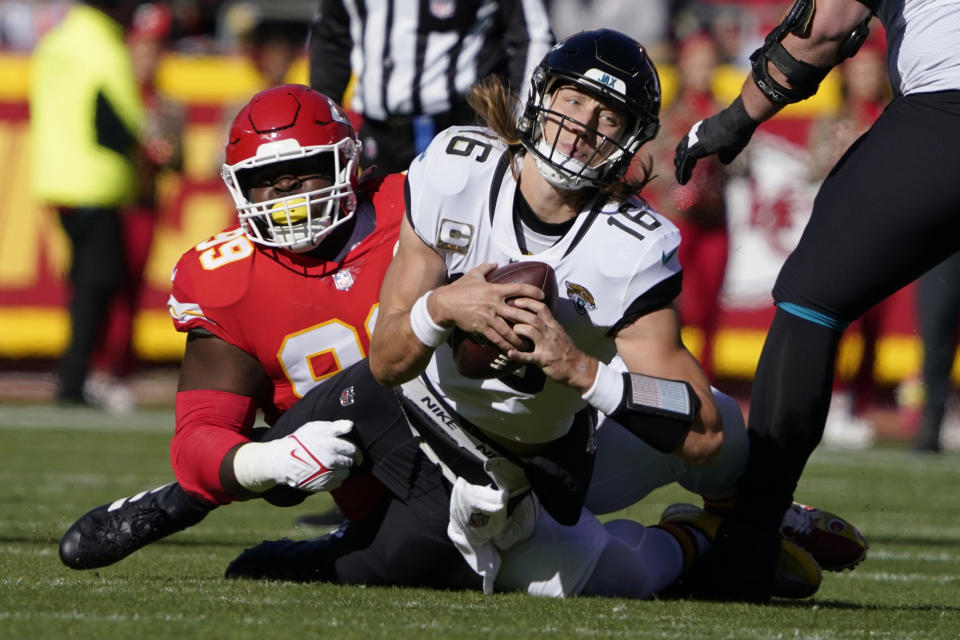 Kansas City Chiefs defensive tackle Khalen Saunders, left, sacks Jacksonville Jaguars quarterback Trevor Lawrence (16) during the first half of an NFL football game Sunday, Nov. 13, 2022, in Kansas City, Mo. (AP Photo/Ed Zurga)