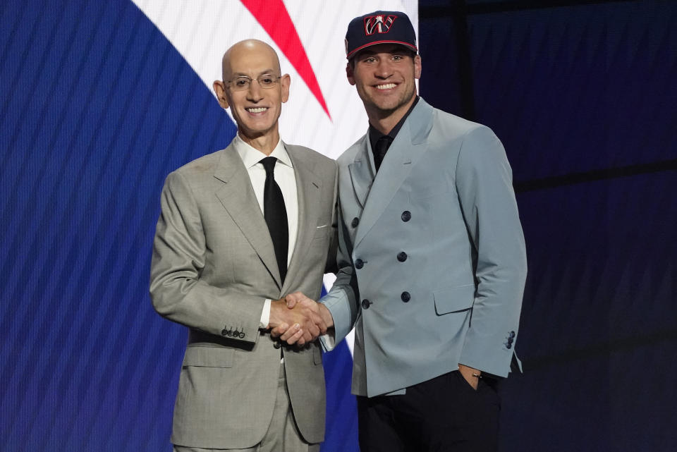 Corey Kispert, right, poses for a photo with NBA Commissioner Adam Silver after being selected 15th overall by the Washington Wizards during the NBA basketball draft, Thursday, July 29, 2021, in New York. (AP Photo/Corey Sipkin)