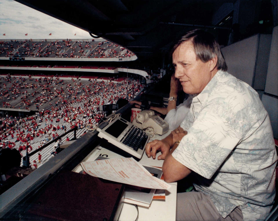 In this circa 1988 photo, AP sports writer Ed Shearer covers an NCAA college football game between Georgia and Tennessee at Sanford Stadium in Athens, Ga. Shearer, a longtime sports writer with The Associated Press who covered the Olympics, Super Bowl, World Series and Hank Aaron's 715th homer but left his most lasting mark as the "SEC Seer," a prognosticator of Southern football known throughout the nation, died Monday., June 14, 2019. He was 82. (AP Corporate Archives via AP)
