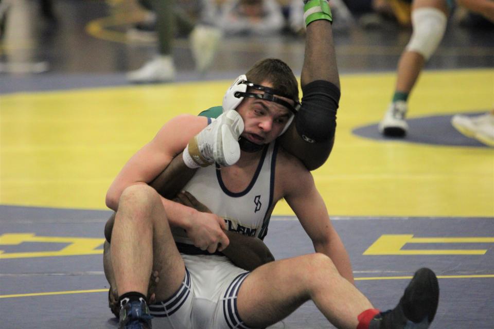 Hartland's Vinnie Abbey takes the shoe of  West Bloomfield's Jason Onwenu to the face during the 157-pound championship match at the Division 1 individual wrestling regional tournament Saturday, Feb. 18, 2023 at Hartland.