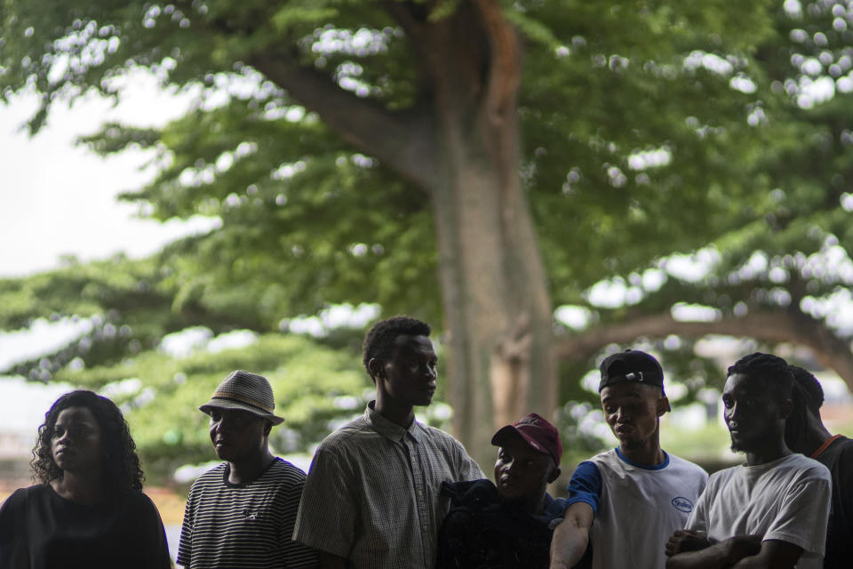 Voters queue outside a polling station during the presidential elections in Kinshasa, Democratic Republic of Congo, Wednesday, Dec. 20, 2023. Congo headed to the polls Wednesday to vote for president as authorities scrambled to finalise preparations in an election facing steep logistical and security challenges. (AP Photo/Mosa'ab Elshamy)