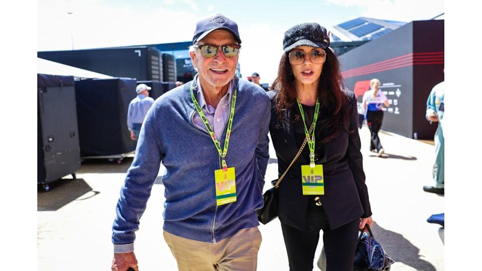 couple walking together at motor racing event