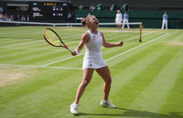 Jasmine Paolini holds her arms out in celebration