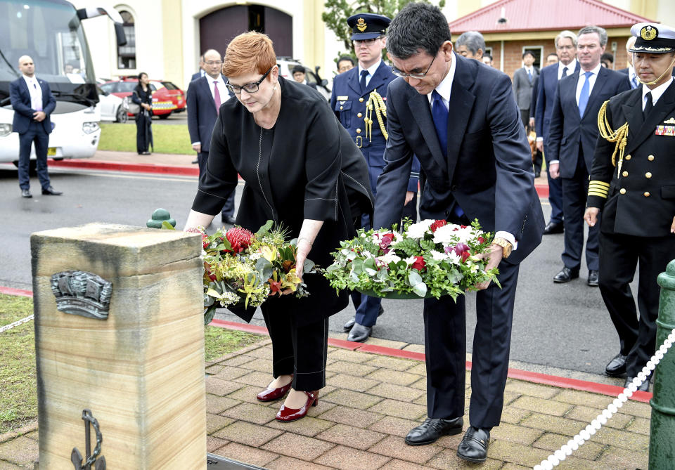 Japanese Foreign Minister Taro Kono, right, and Australian Foreign Minister Marise Payne lay wreaths at HMAS Kuttabul in Sydney, Wednesday, Oct. 10, 2018. Australia and Japan on Wednesday reaffirmed their commitment to pressuring North Korea to abandon its nuclear weapons program and enforcing sanctions on Pyongyang. (Brendan Esposito/AAP Images via AP)