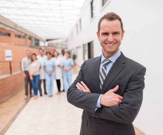 A man in a suit smiling