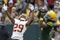 Green Bay Packers' Davante Adams catches a pass in front of Washington Football Team's Kendall Fuller during the second half of an NFL football game Sunday, Oct. 24, 2021, in Green Bay, Wis. (AP Photo/Matt Ludtke)