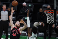 Toronto Raptors center Aron Baynes (46) shoots over Boston Celtics center Robert Williams III during the first half of an NBA basketball game, Thursday, March 4, 2021, in Boston. (AP Photo/Charles Krupa)