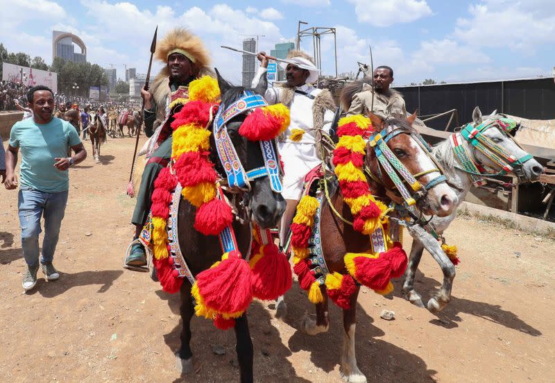 Ethiopian Oromo musician, Haacaaluu Hundeessaa, rides a horse in traditional costume in Addis Ababa