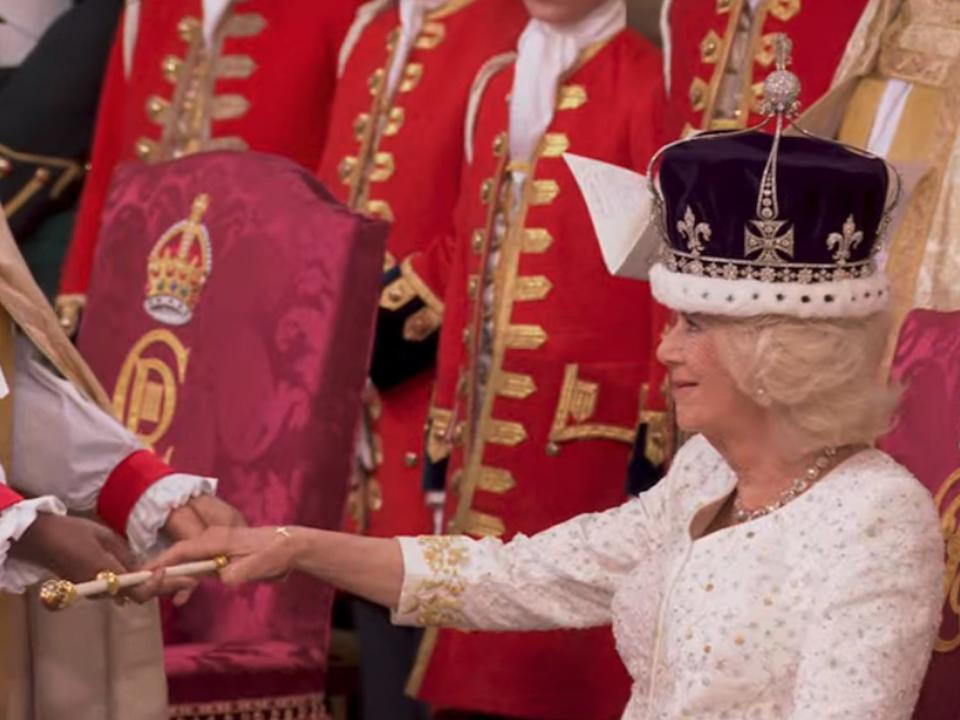 Queen Camilla receives the royal rod during her coronation ceremony on May 6, 2023.