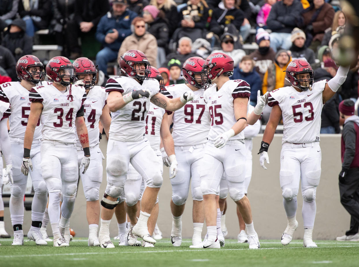 WEST POINT, NY - NOVEMBER 17: T.J. Holl #21, John Steffen #95, Alec Wisniewski #34, and Caleb Fell #53 of the Colgate Raiders pump up the fans during a game against the Army Black Knights at Michie Stadium on November 17, 2018 in West Point, New York. (Photo by Dustin Satloff/Getty Images)