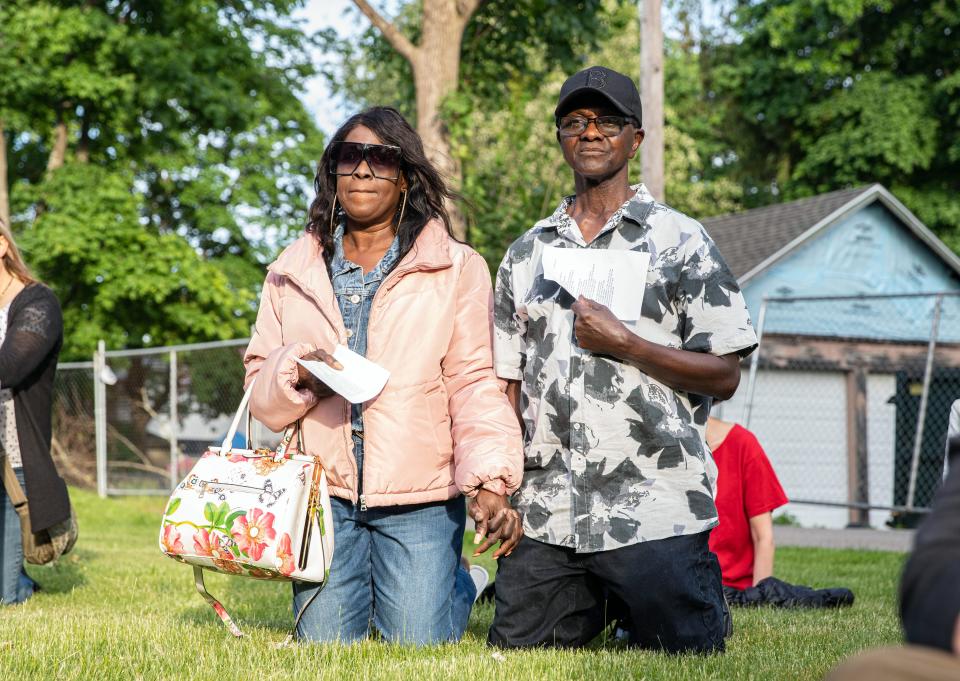 Debra Forrester and Joseph Forrester, of Milton, kneel during the vigil for George Floyd in front of the Parkway United Methodist Church in Milton, Wednesday, May 25, 2022.