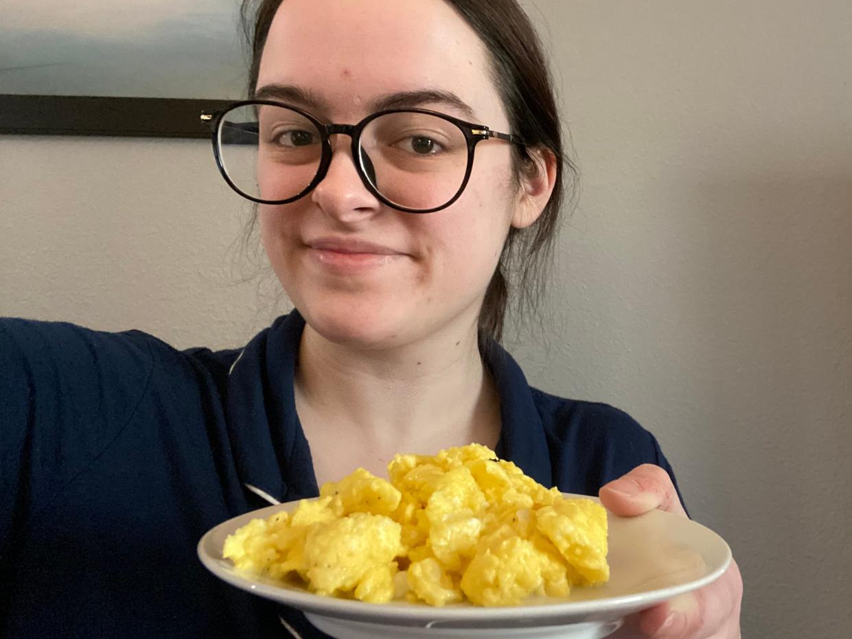 paige bennett holding a plate of scrambled eggs