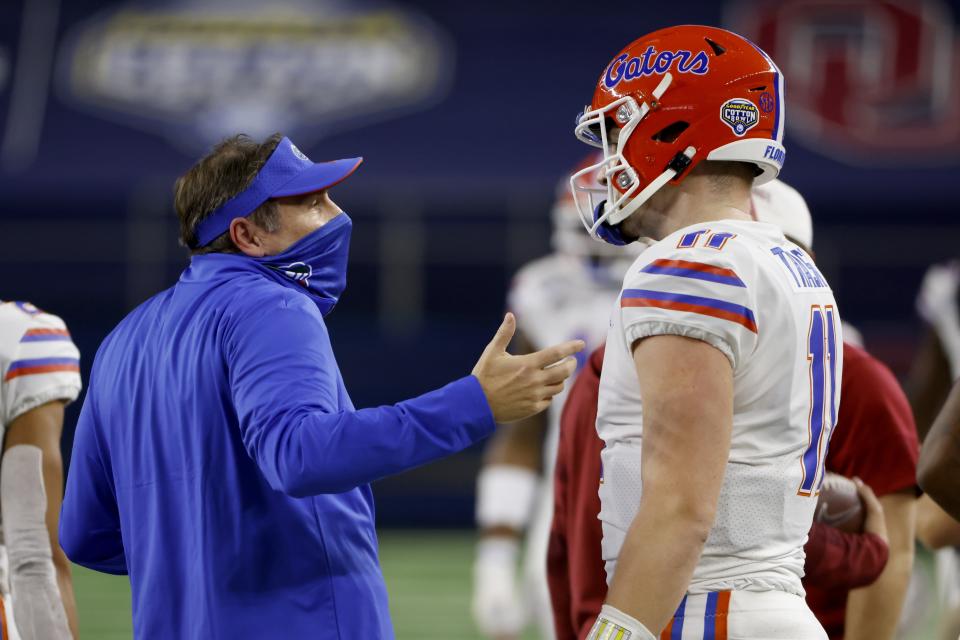 Florida coach Dan Mullen talks with quarterback Kyle Trask after Trask threw a pass into the end zone that was intercepted by Oklahoma's Woodi Washington during the first half of the Cotton Bowl NCAA college football game in Arlington, Texas, Wednesday, Dec. 30, 2020. (AP Photo/Ron Jenkins)