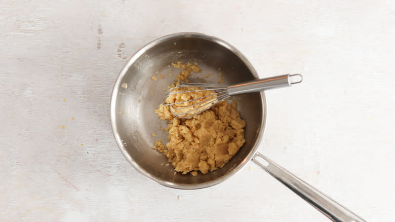 pate a choux in pan with whisk