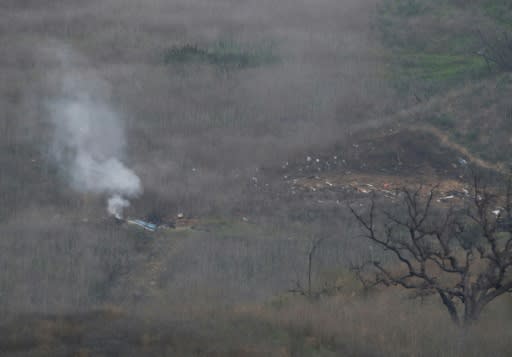 Smoke rises from the site of a helicopter crash in Calabasas, California on January 26, 2020 that killed nine people including NBA legend Kobe Bryant