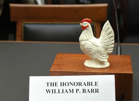 A statue of a chicken sits above the nameplate and near the empty seat of U.S. Attorney General William Barr, who was scheduled to appear at a House Judiciary Committee hearing on the Justice Department's investigation of Russian interference with the 2016 presidential election, on Capitol Hill in Washington, U.S., May 2, 2019. REUTERS/Clodagh Kilcoyne