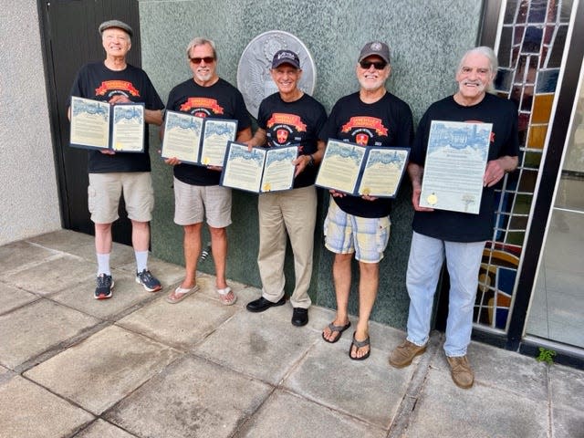 The five surviving Gainesville Eight members receive a proclamation 50 years after one of several Nixon-era conspiracy trials aimed at suppressing anti-war activism. (Left to right: Peter Mahoney, John Briggs, Don Perdue, Stanley Michelsen and Scott Camil.