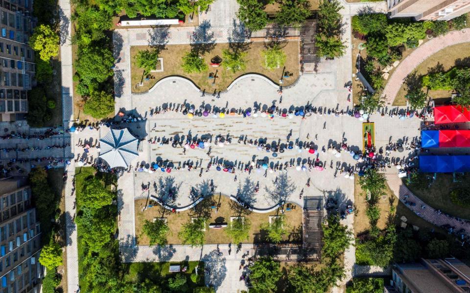 People queueing to receive nucleic acid testing for the Covid-19 in Huaian, in eastern China's Jiangsu province - AFP