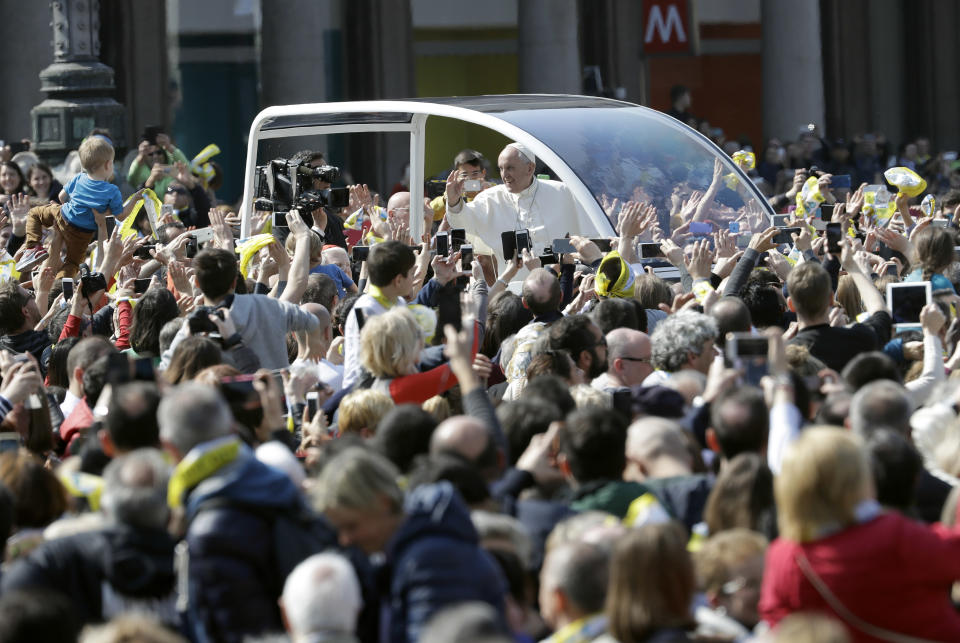 Pope Francis waves to the crowd as leaves after visiting Milan’s Duomo Cathedral where he met priests and members of the Catholic Church, as part of his one-day pastoral visit to Monza and Milan, Italy’s second-largest city, Saturday, March 25, 2017. Pope Francis began his one-day visit Saturday to the world's largest diocese which included a stop at the city's main prison as well as a blessing at the Gothic-era Duomo cathedral. (AP Photo/Luca Bruno)