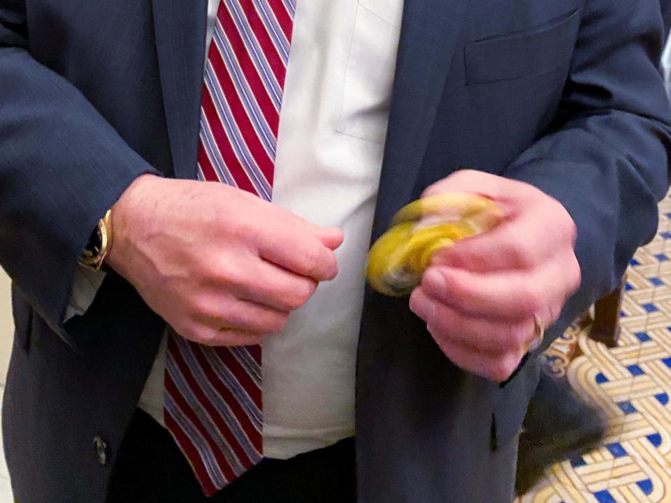 Senator Mike Rounds plays with a fidget spinner handed out to Republicans during the impeachment trial: REUTERS