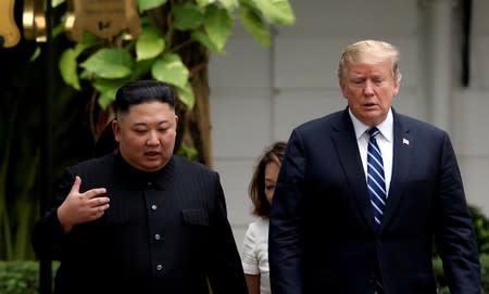 FILE PHOTO: North Korea's leader Kim Jong Un and U.S. President Donald Trump talk in the garden of the Metropole hotel during the second North Korea-U.S. summit in Hanoi