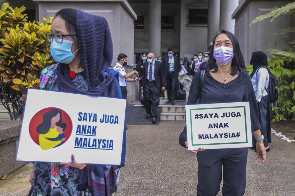 Members of Family Frontiers hold up placards demanding equal citizenship rights for Malaysians at the Kuala Lumpur High Court April 27, 2021. — Picture by Hari Anggara