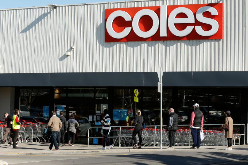 People line up outside a Coles supermarket in Malvern in Melbourne, Australia. 