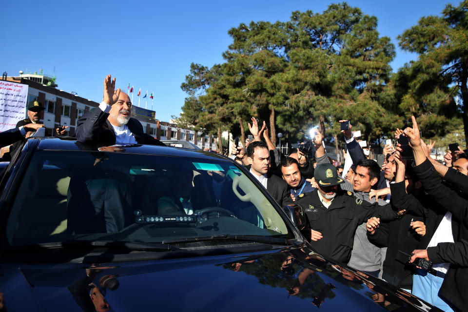 Iranian Foreign Minister Mohammad Javad Zarif, who is also Iran's top nuclear negotiator, waves to his well wishers upon arrival at the Mehrabad airport in Tehran, Iran, from Lausanne, Switzerland, Friday, April 3, 2015.  (AP Photo/Ebrahim Noroozi)
