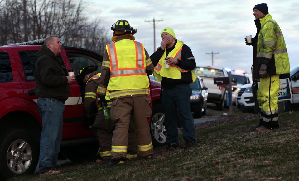 Firefighters and other emergency workers at the scene near Silver Lake, where a submerged SUV was found with a baby inside in Highland, Ill., on Thursday, March 16, 2017. The infant is being treated at a St. Louis hospital after the car the child was in rolled into the lake. (Robert Cohen/St. Louis Post-Dispatch via AP)