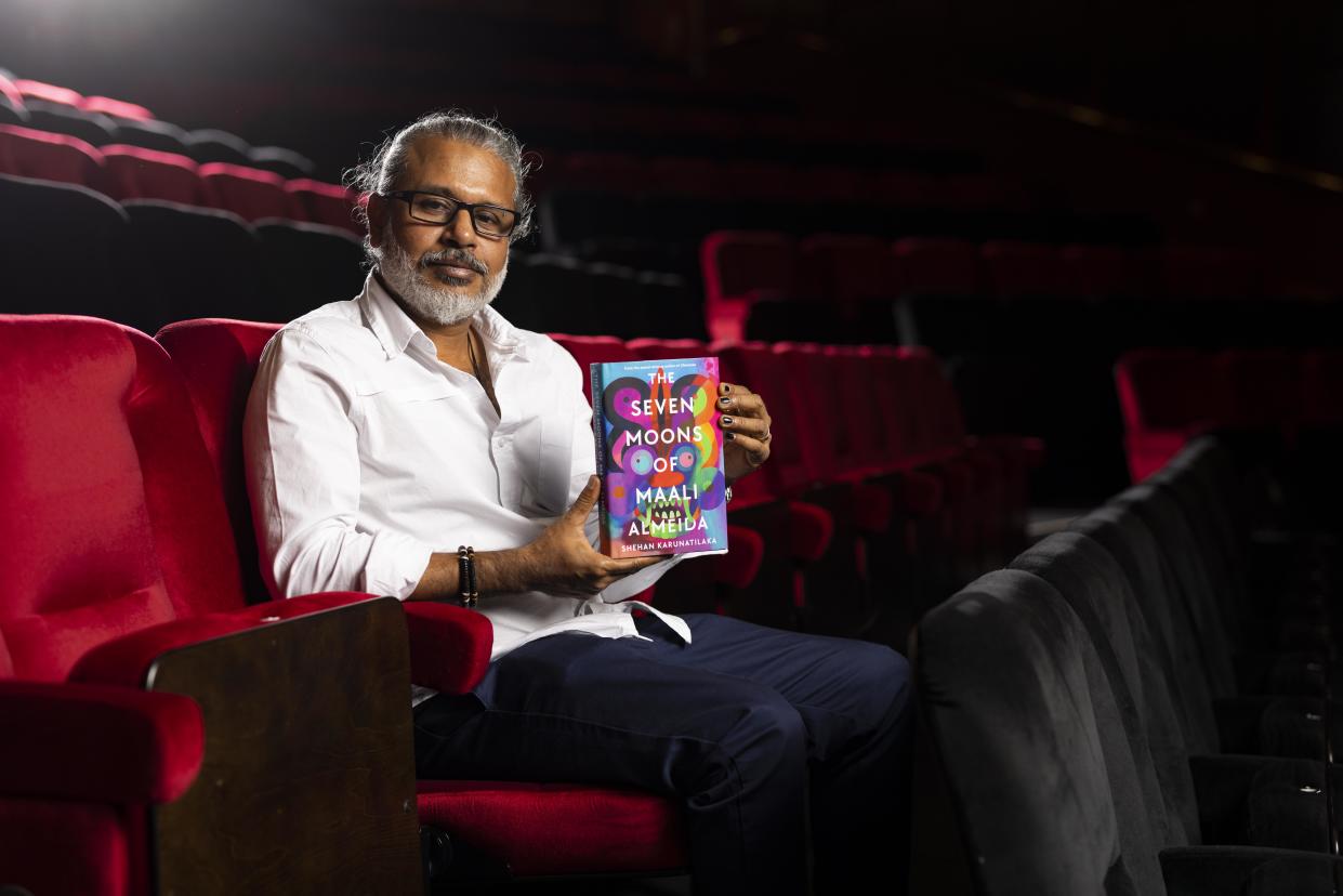 Karunatilaka with his winning book (Booker Prize Foundation/PA)