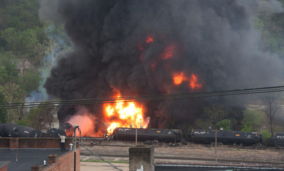 In this image made available by the City of Lynchburg, shows several CSX tanker cars carrying crude oil in flames after derailing in downtown Lynchburg, Va., Wednesday, April 30, 2014. (AP Photo/City of Lynchburg, LuAnn Hunt)