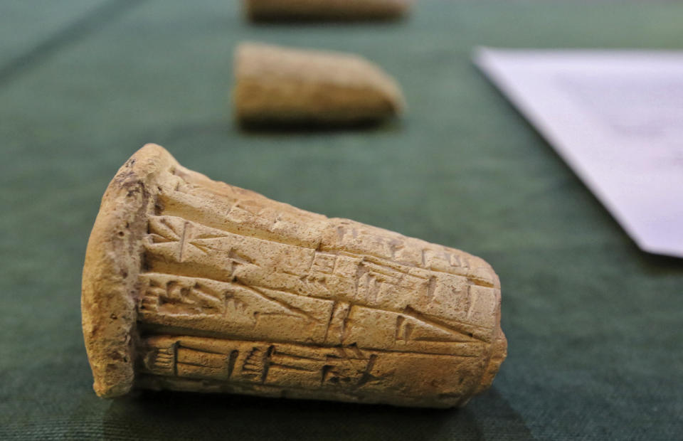 Mesopotamian clay cones bearing cuneiform inscriptions are displayed during a handover ceremony of a trove of looted Iraqi antiquities returned by the United States, at the Ministry of foreign Affairs in the capital Baghdad, on August 3, 2021. On July 28, Iraq's culture ministry said the US would return some 17,000 archaeological treasures dating back 4,000 years and looted in recent decades, in an 