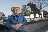 Ron Turcotte poses next to a statue of him and Secretariat in Grand Falls, New Brunswick, Canada, on Wednesday, May 31, 2023. Turcotte rose to the heights of the horse racing world, riding Secretariat to a sweep of the Kentucky Derby, Preakness and Belmont in 1973. (AP Photo/Stephen MacGillivray)