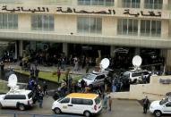 Journalists gather outside the building of Lebanese Press Syndicate where former Nissan chairman Carlos Ghosn is expected to hold a news conference in Beirut