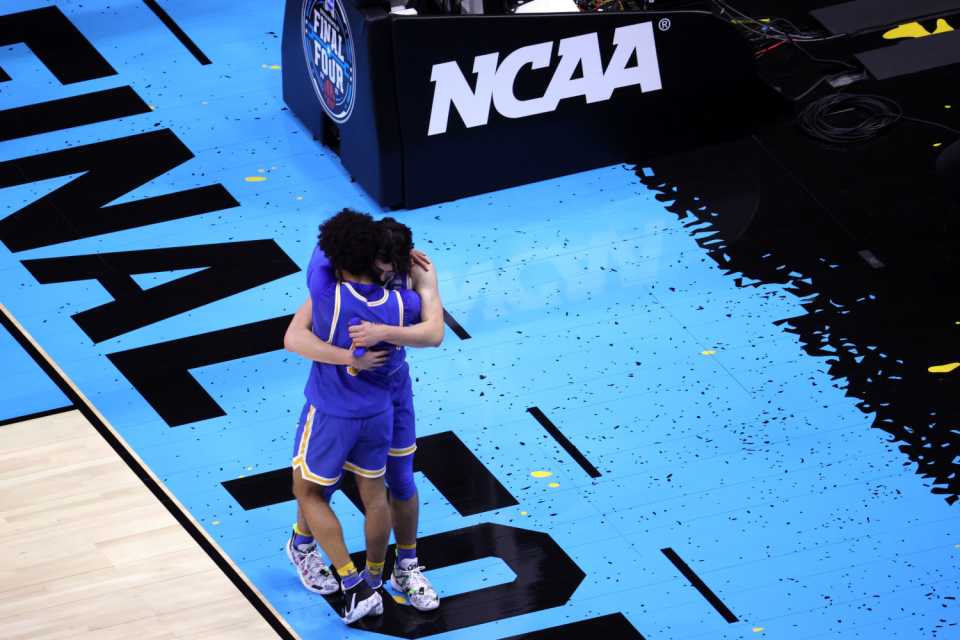 UCLA teammates Jaime Jaquez Jr., top, and Johnny Juzang hug after losing to Gonzaga in the Final Four on Saturday.