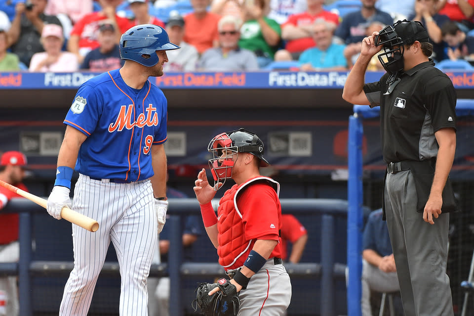 Tim Tebow reacts to a called third strike in his first spring training at-bat. (Reuters)